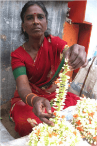 Disabled woman collecting thrown out flowers to resell